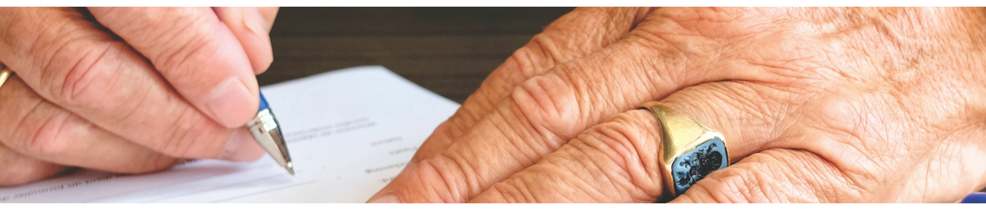 person using  pen to write on pad