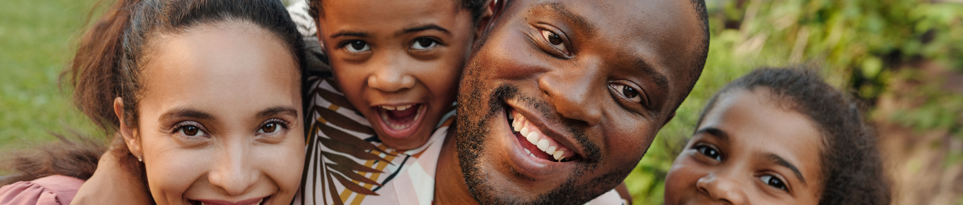 facial shot of family including mother, son, father, and daughter